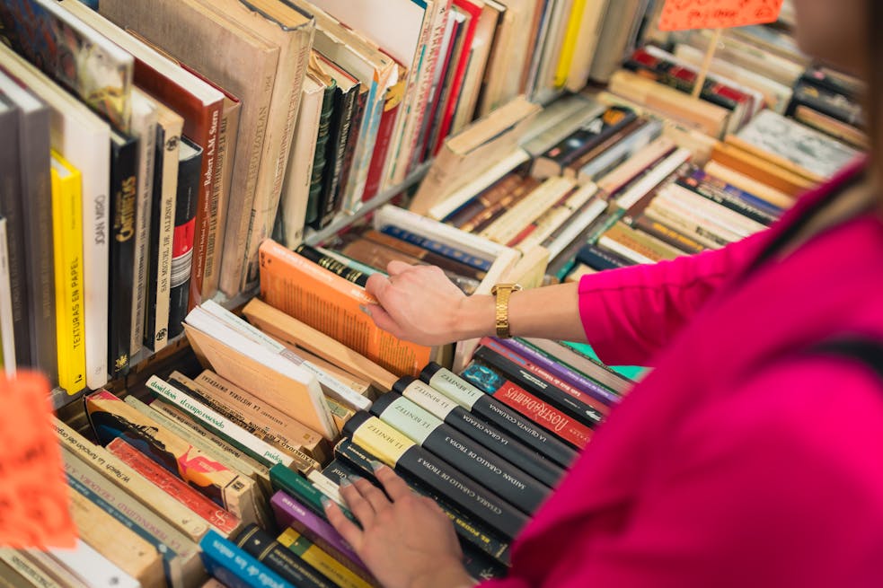 A person browsing colorful books in a charming bookstore in Mexico City, emphasizing culture and knowledge.